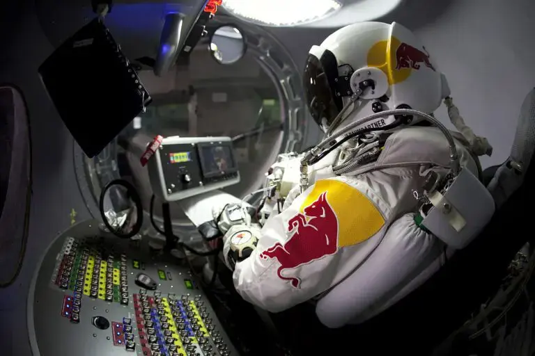 Felix Baumgartner in Red Bull Stratos helium balloon capsule preparing for space jump.