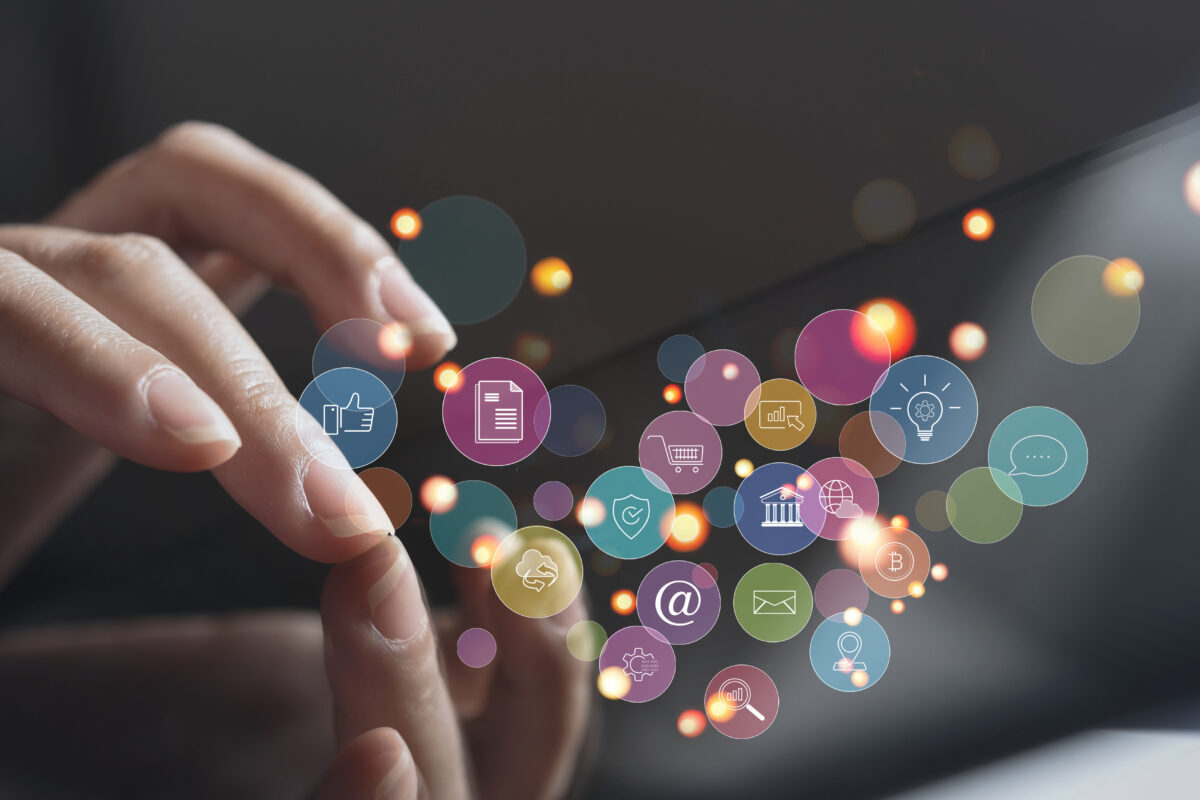Futuristic image of hand typing with floating icons representing partnership marketing trends.