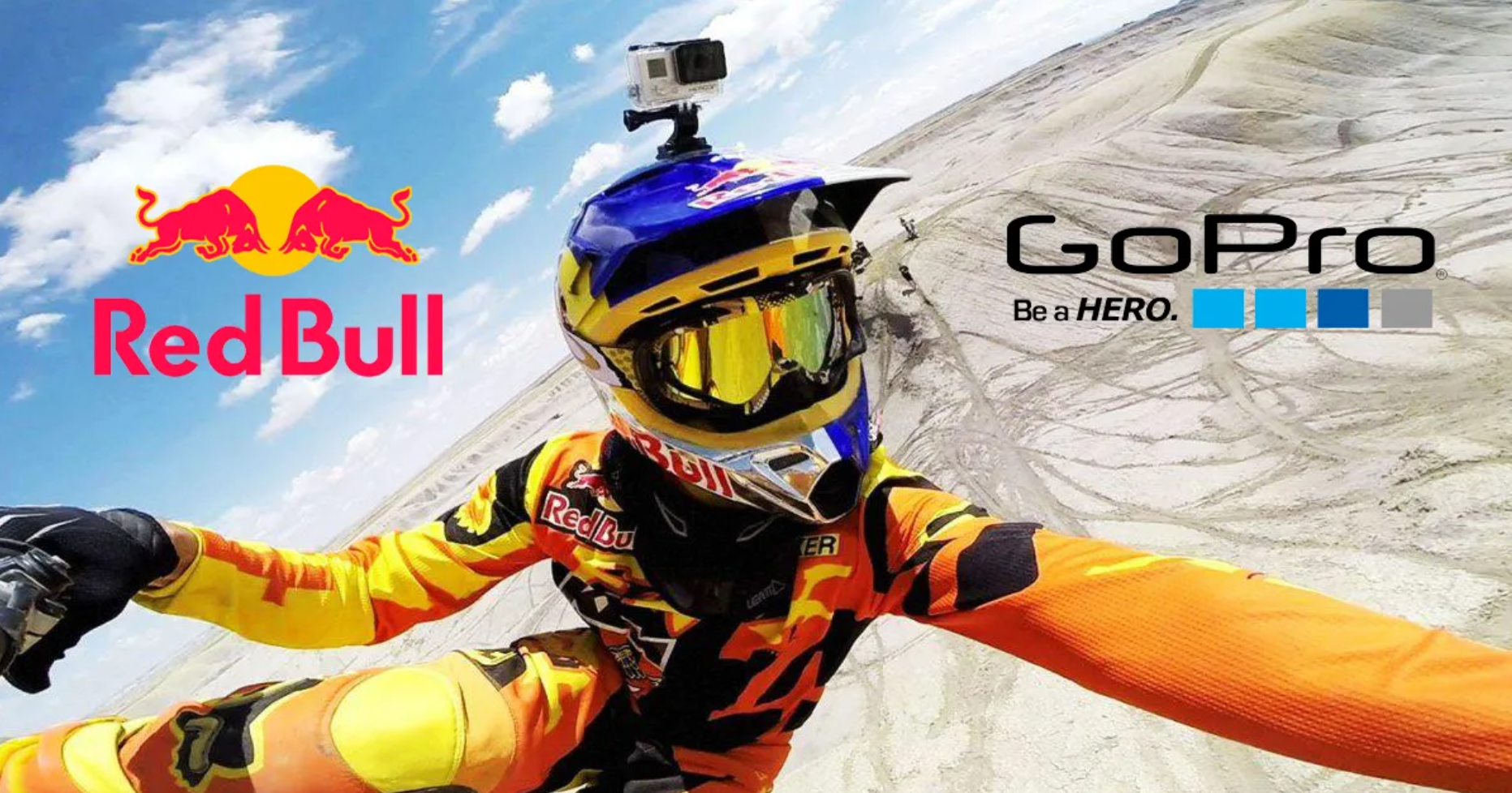 Red Bull and GoPro logos on a mountainous background with a RedBull athlete wearing a GoPro camera.
