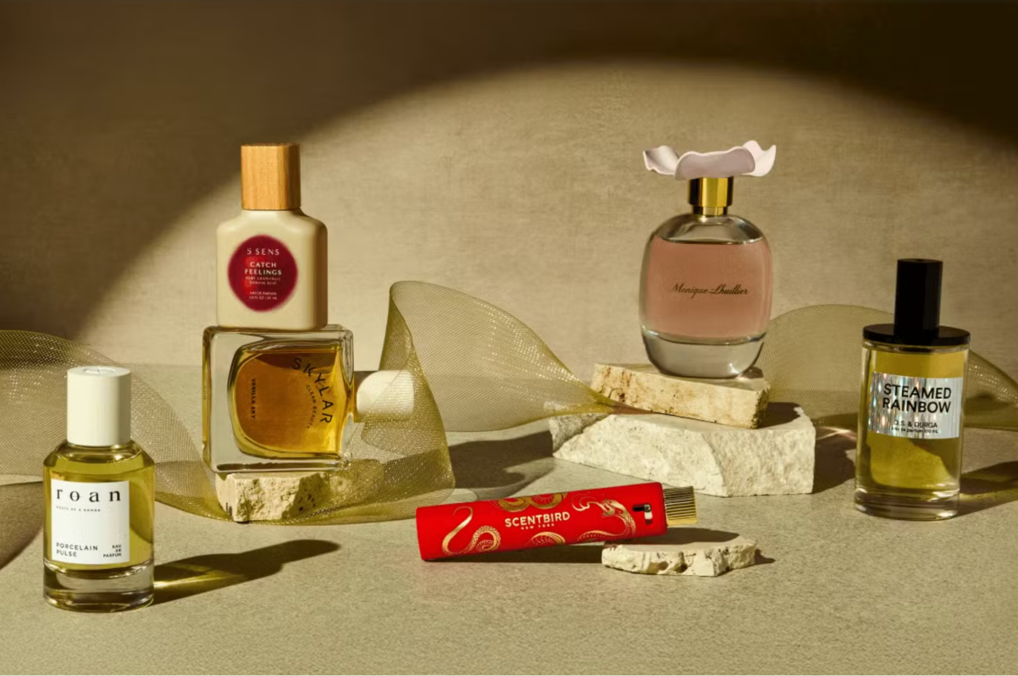 Image showcasing fragrances with a Scentbird atomizer