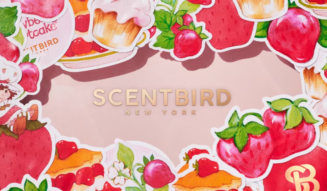 Colorful illustrated stickers of strawberries, cupcakes, and desserts frame the word "SCENTBIRD NEW YORK" on a light pink background.
